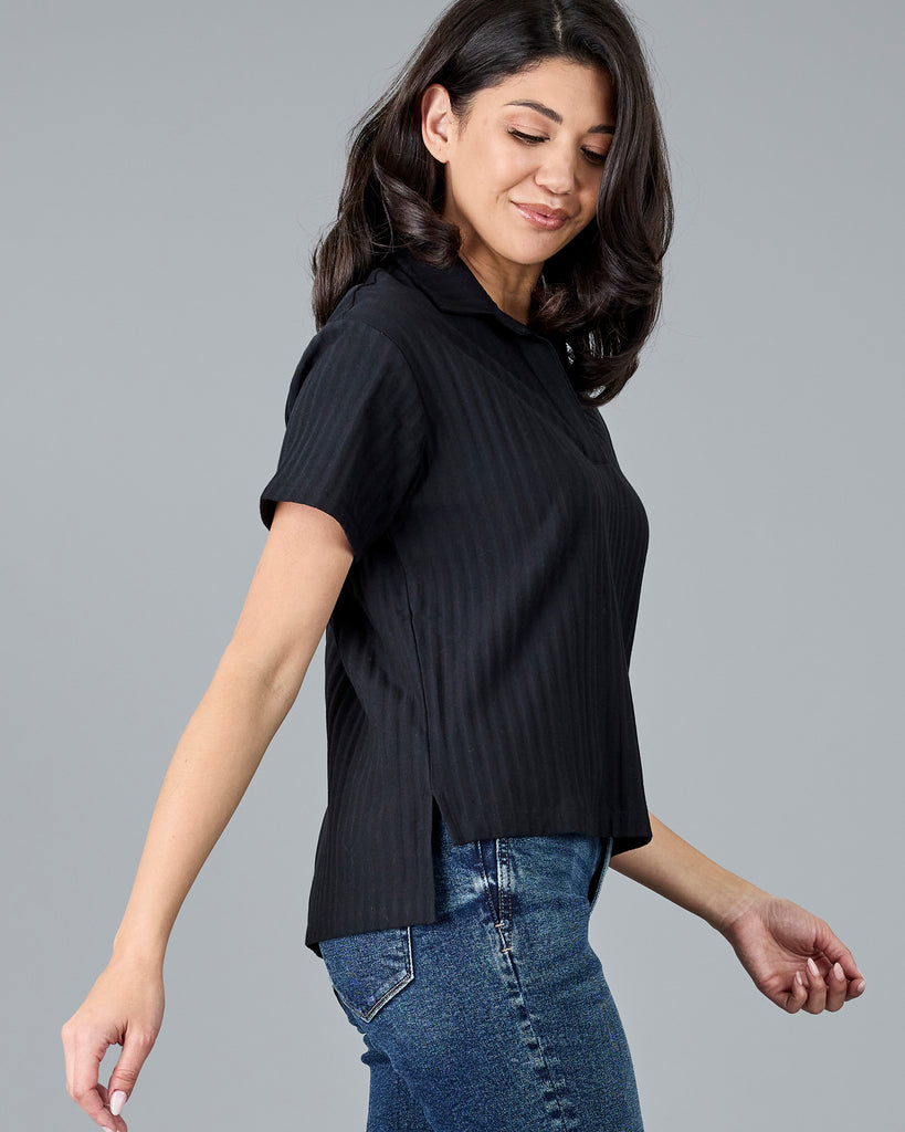 Woman in a black short sleeve polo