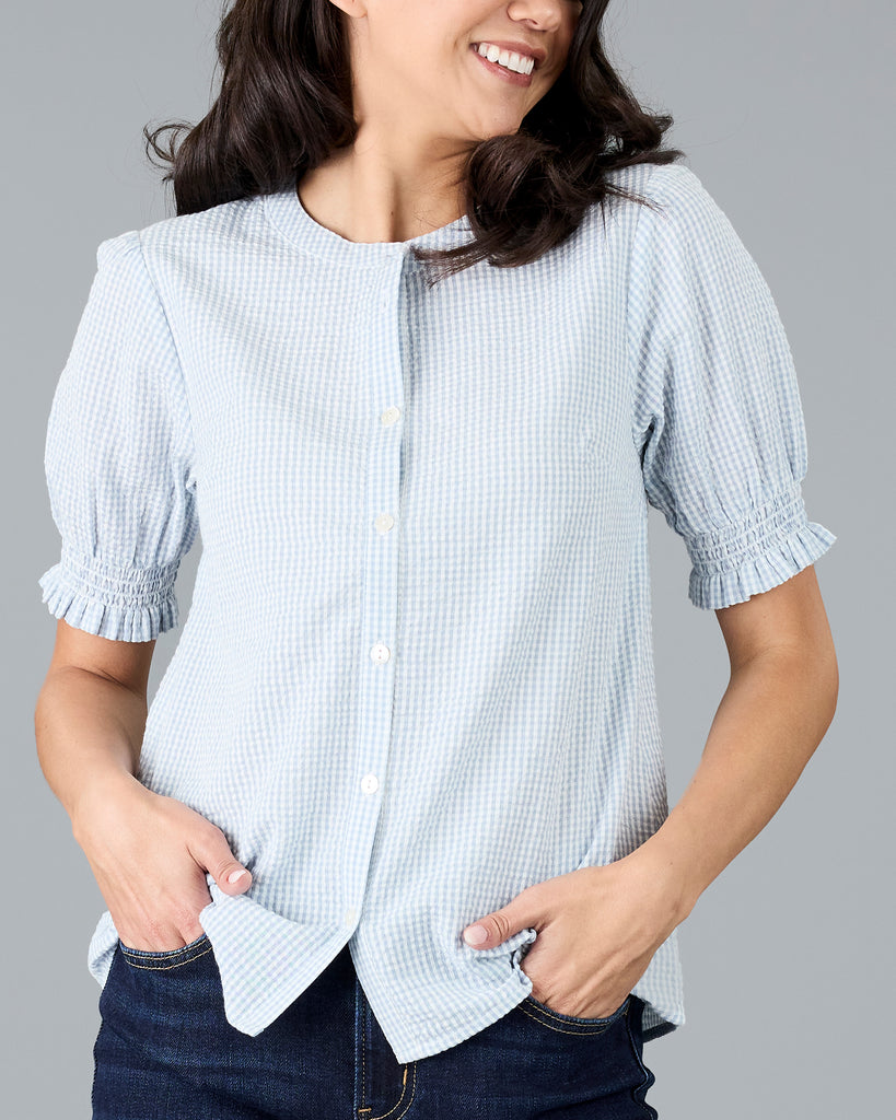 Woman in a short sleeve gingham print buttondown blouse