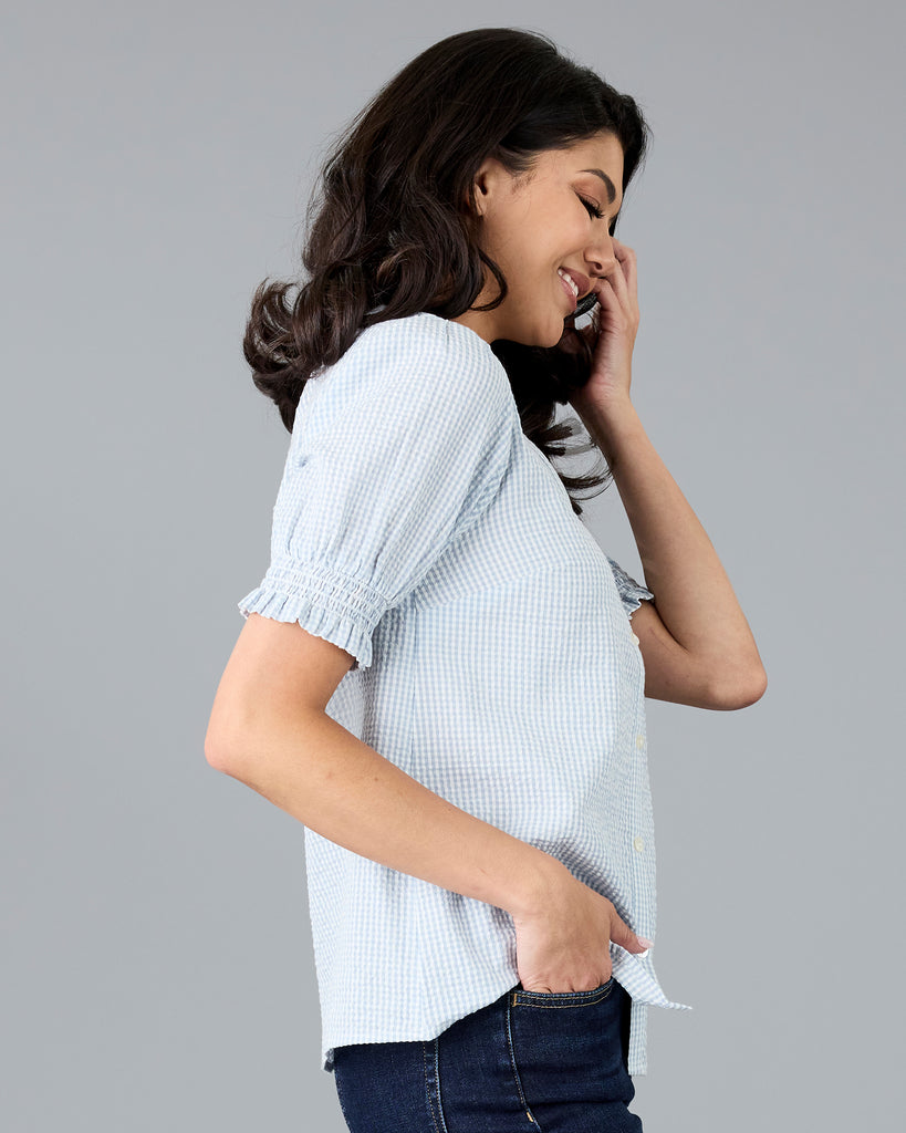 Woman in a short sleeve gingham print buttondown blouse