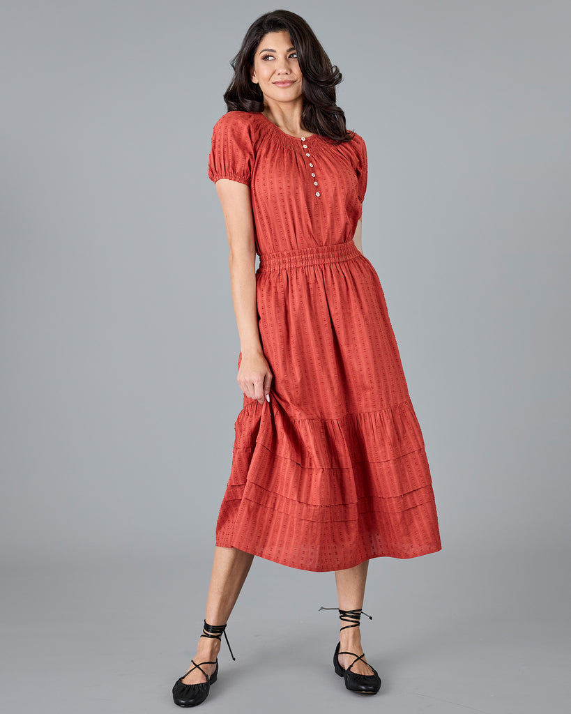 Woman in a short sleeve orange blouse