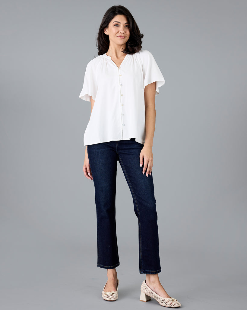 Woman in a short sleeve v-neck white blouse