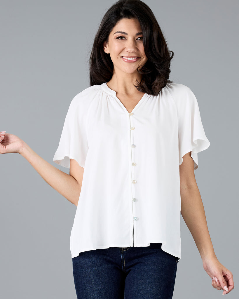 Woman in a short sleeve v-neck white blouse