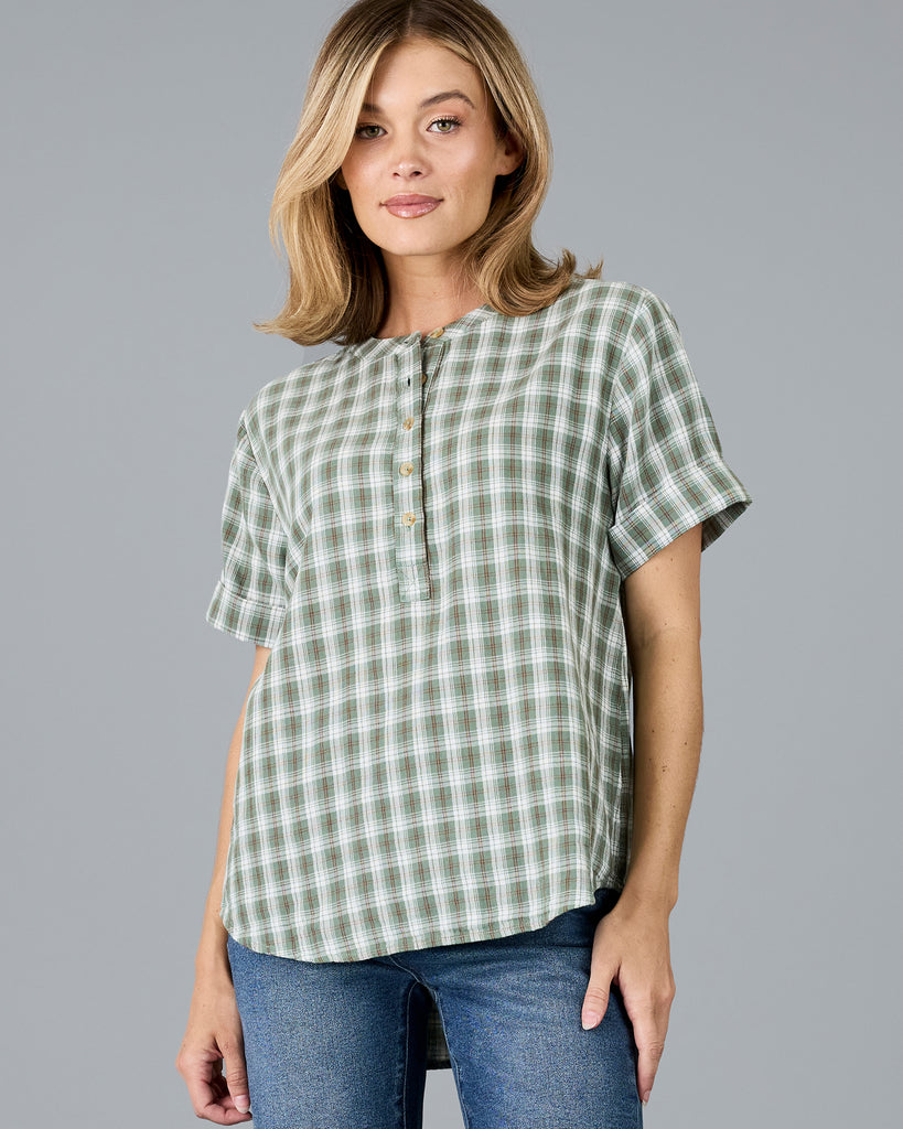 Woman in a plaid green short sleeve blouse