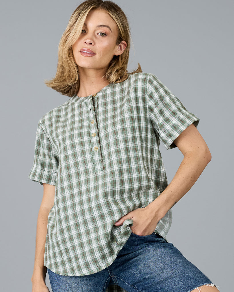 Woman in a plaid green short sleeve blouse