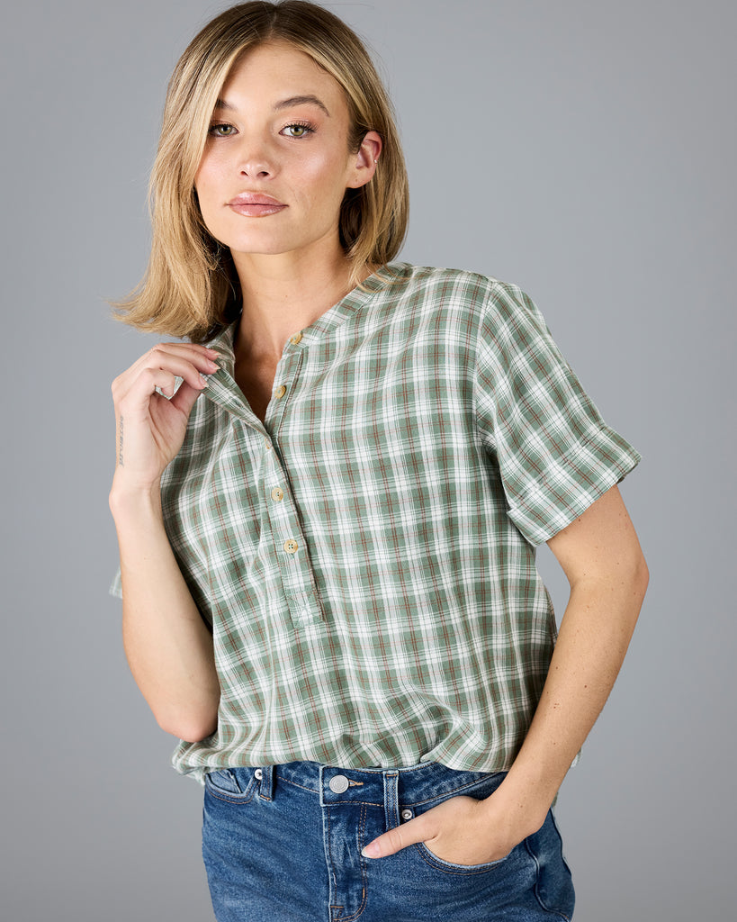 Woman in a plaid green short sleeve blouse