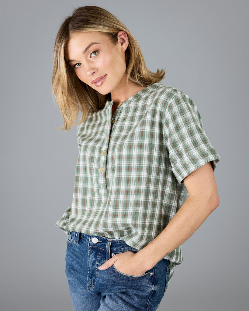 Woman in a plaid green short sleeve blouse