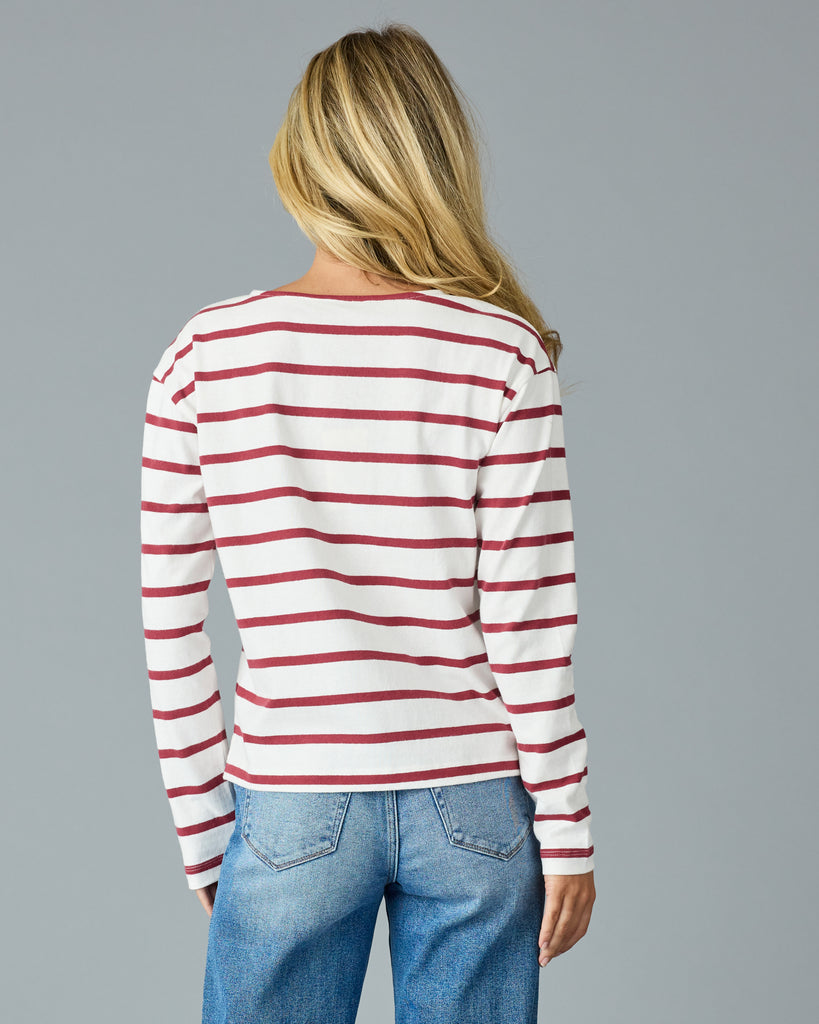 Woman in a red and white striped, long sleeve henley top