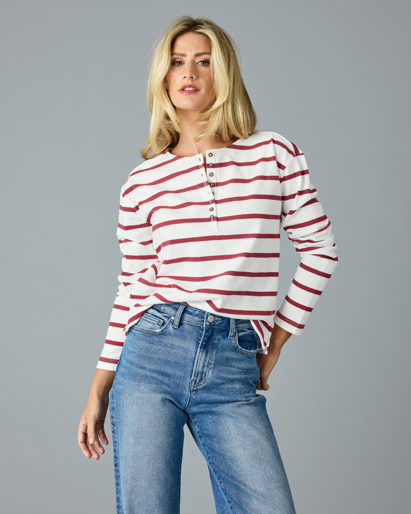 Woman in a red and white striped, long sleeve henley top