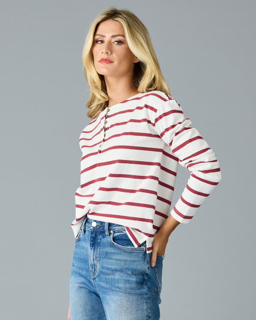 Woman in a red and white striped, long sleeve henley top