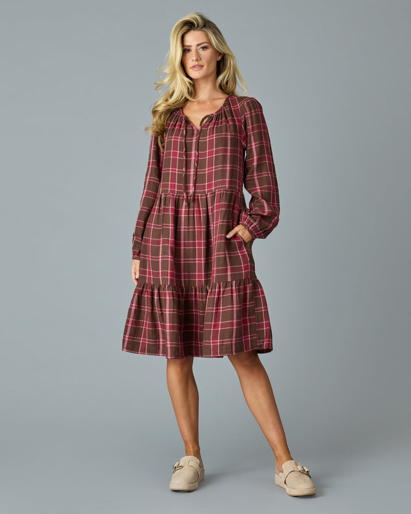 Woman in a maroon plaid, long sleeve, midi dress