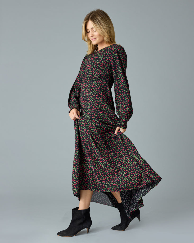 Woman in a black with floral print, long sleeve, v-neck maxi dress