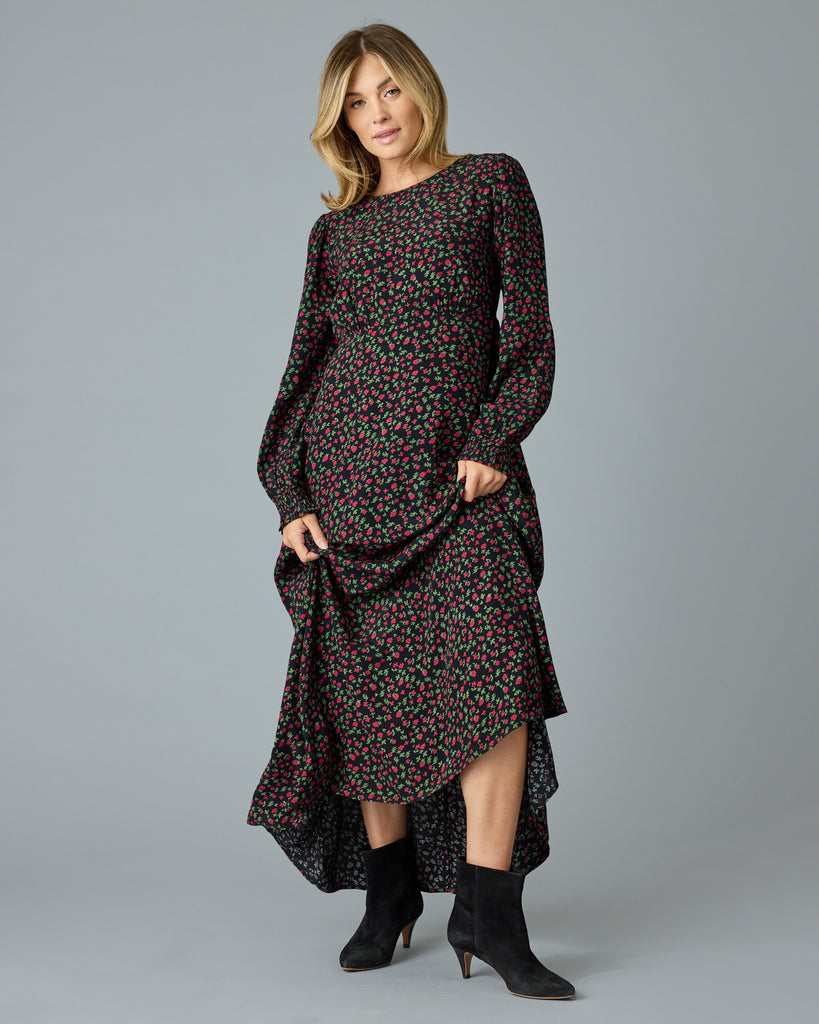 Woman in a black with floral print, long sleeve, v-neck maxi dress