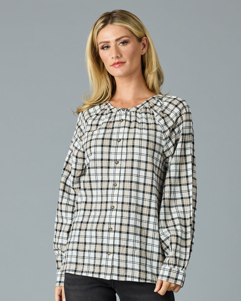 Woman in a black and white plaid long sleeve blouse