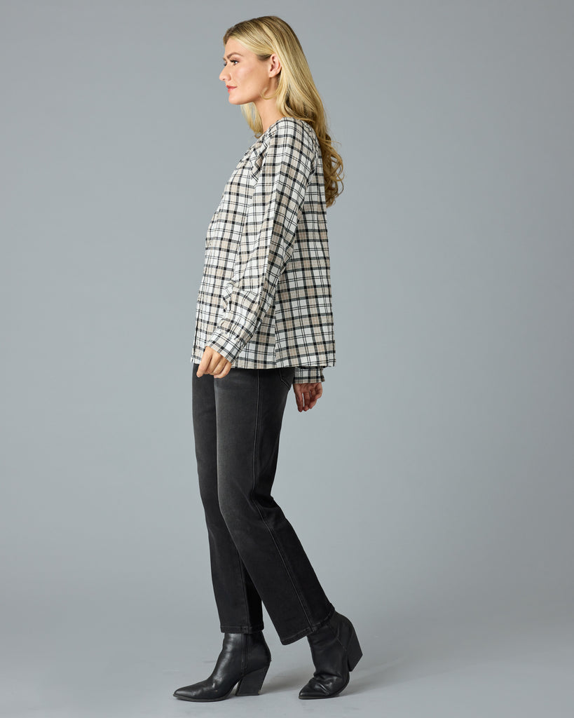 Woman in a black and white plaid long sleeve blouse