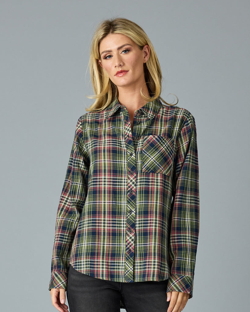 Woman in a green and pink plaid long sleeve buttondown top