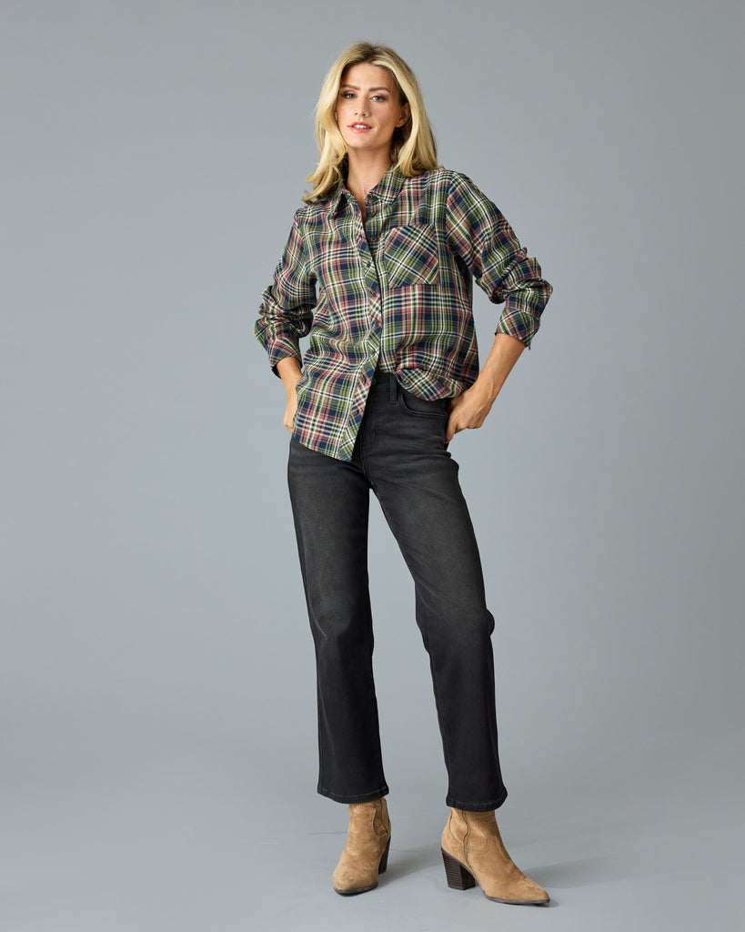 Woman in a green and pink plaid long sleeve buttondown top