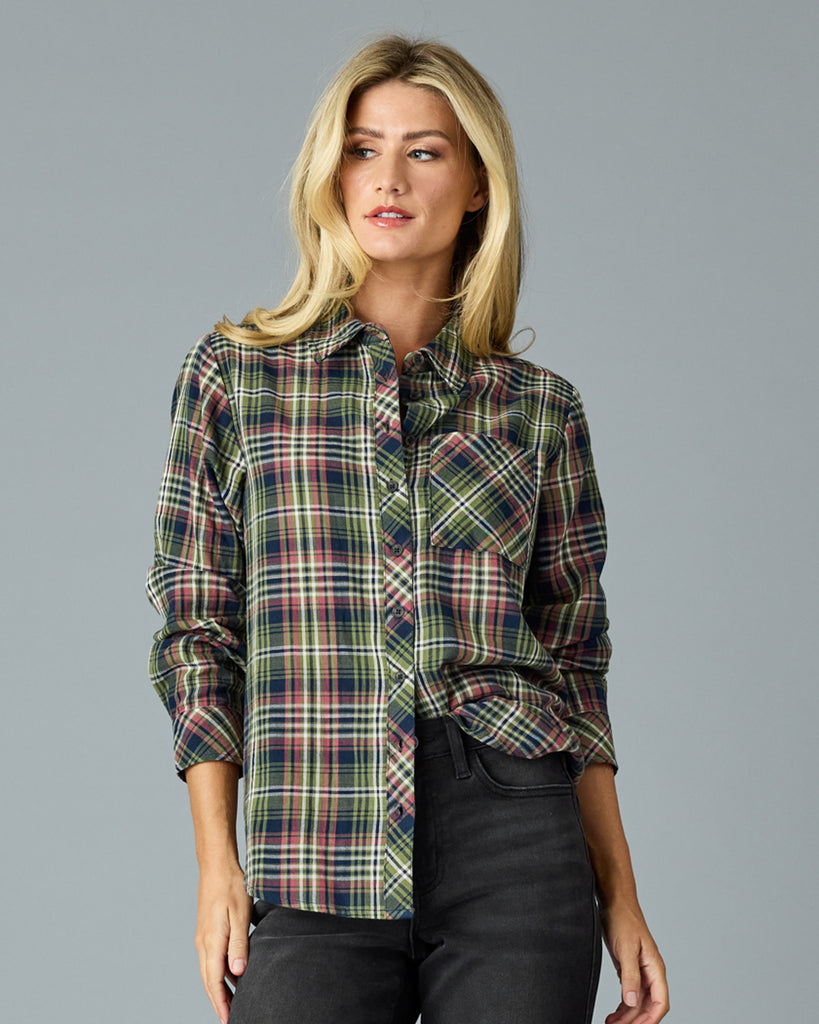 Woman in a green and pink plaid long sleeve buttondown top