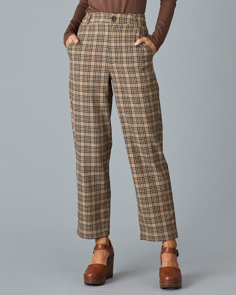 Woman in tan and red plaid trousers