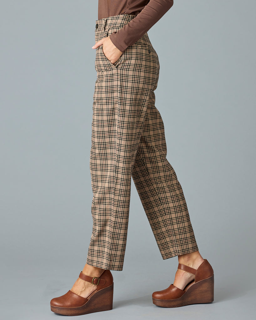 Woman in tan and red plaid trousers