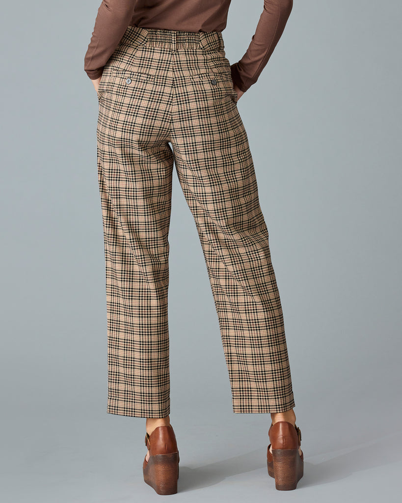 Woman in tan and red plaid trousers