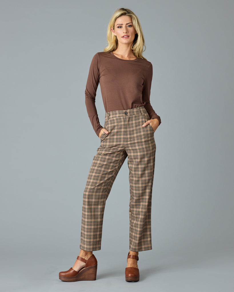 Woman in tan and red plaid trousers