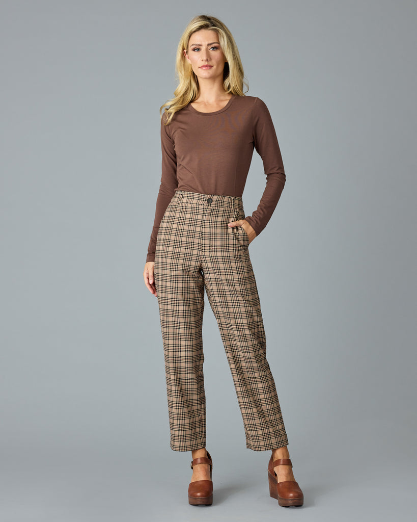 Woman in tan and red plaid trousers