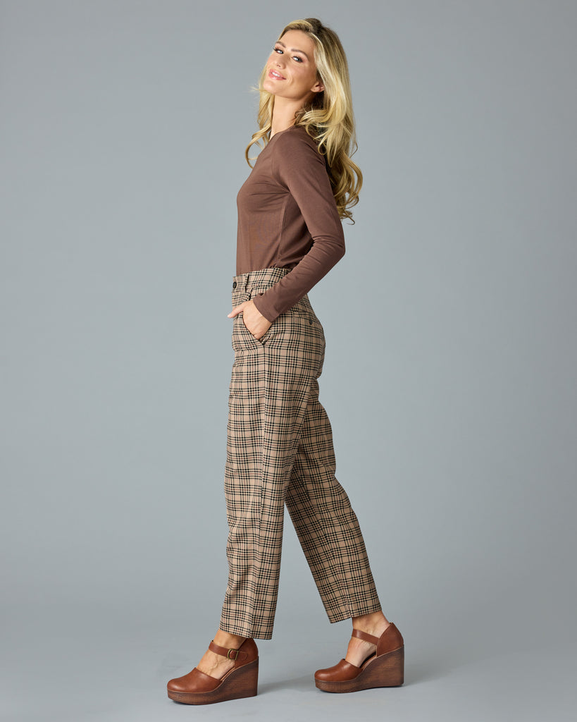 Woman in tan and red plaid trousers