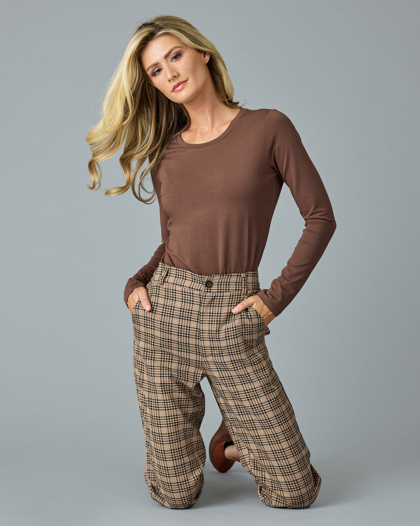 Woman in tan and red plaid trousers