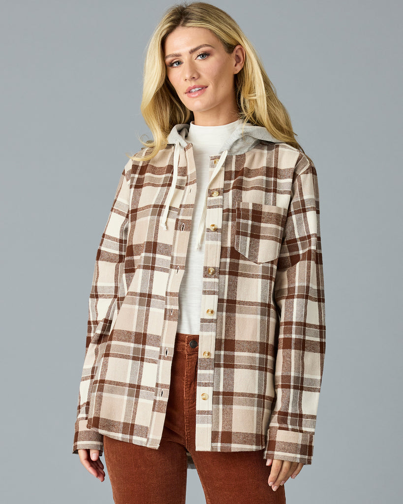 Woman in a tan plaid buttondown with a sweater hood attached