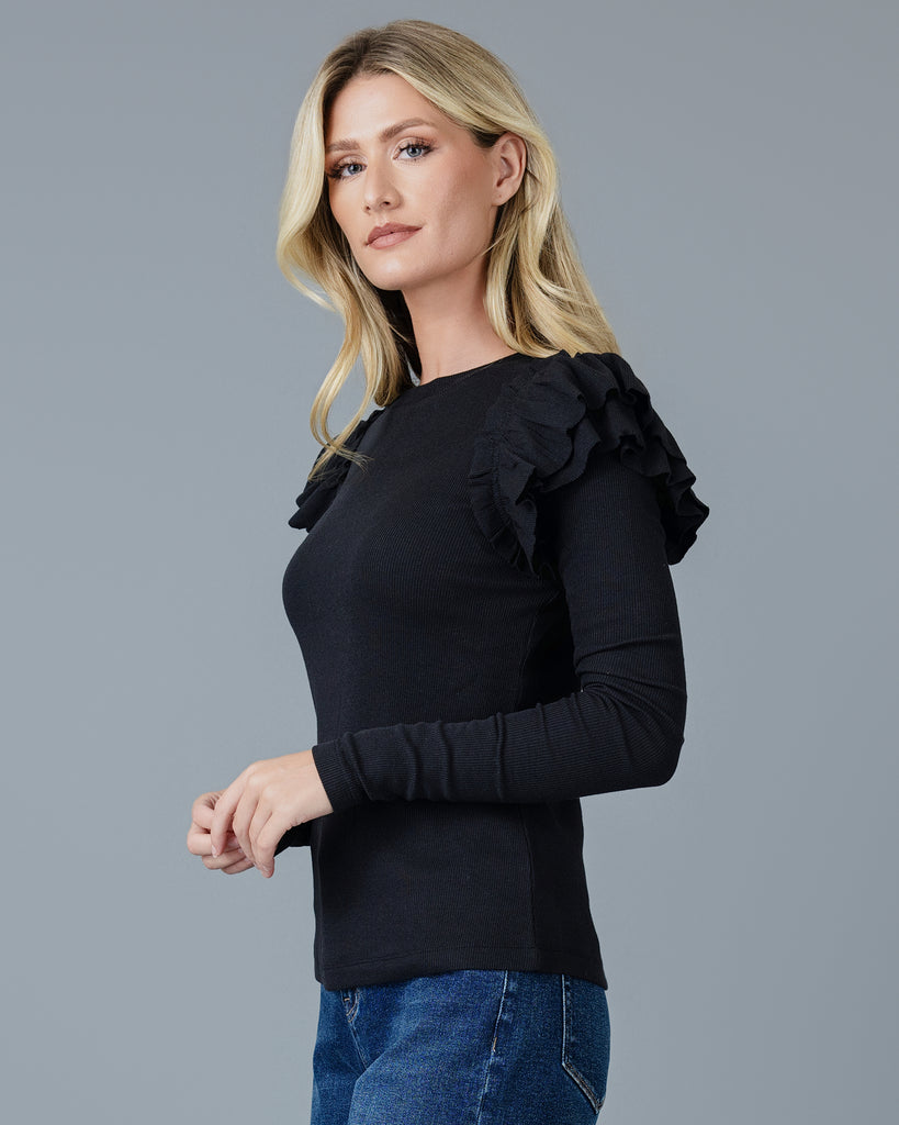 Woman in a black long sleeve t-shirt with double ruffles on shoulders