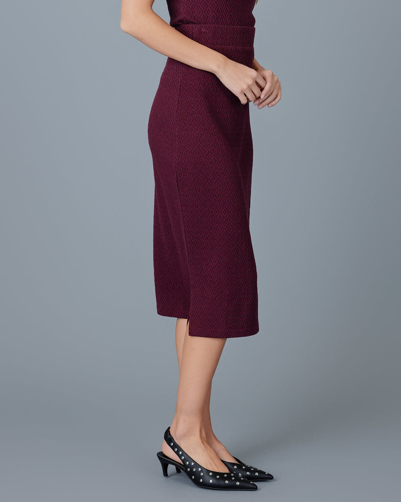 Woman in a plum colored midi length sheath skirt