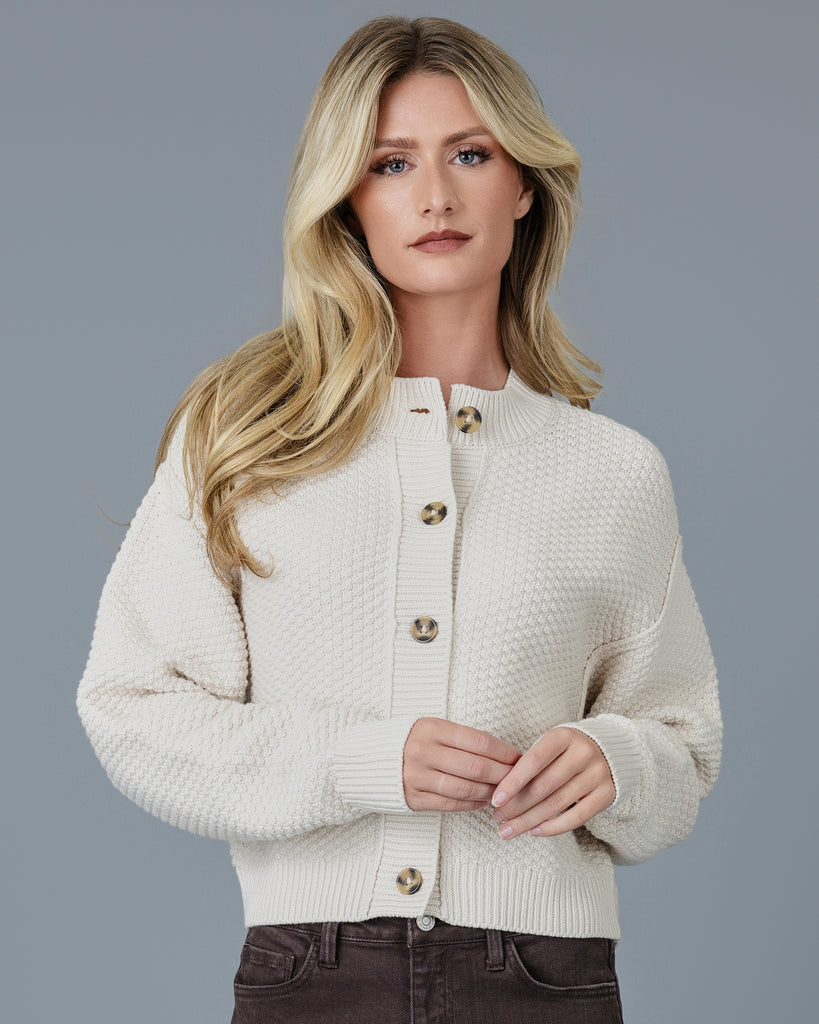 Woman in a beige long sleeve textured cardigan