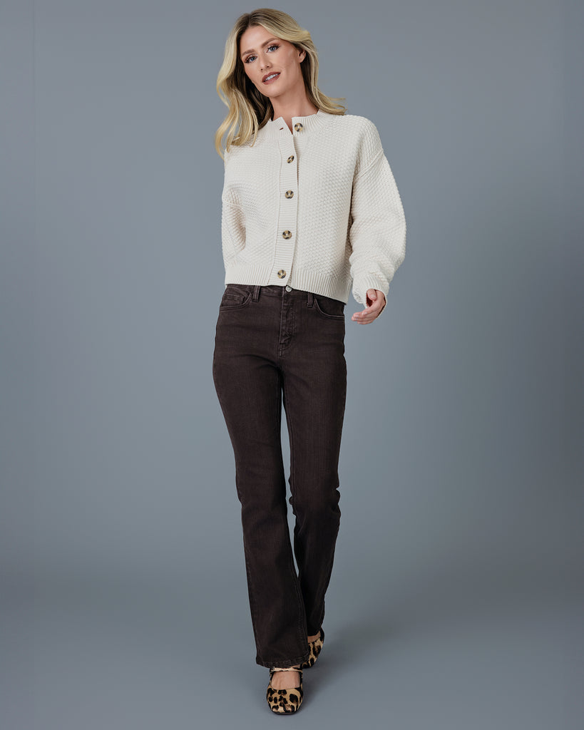 Woman in a beige long sleeve textured cardigan