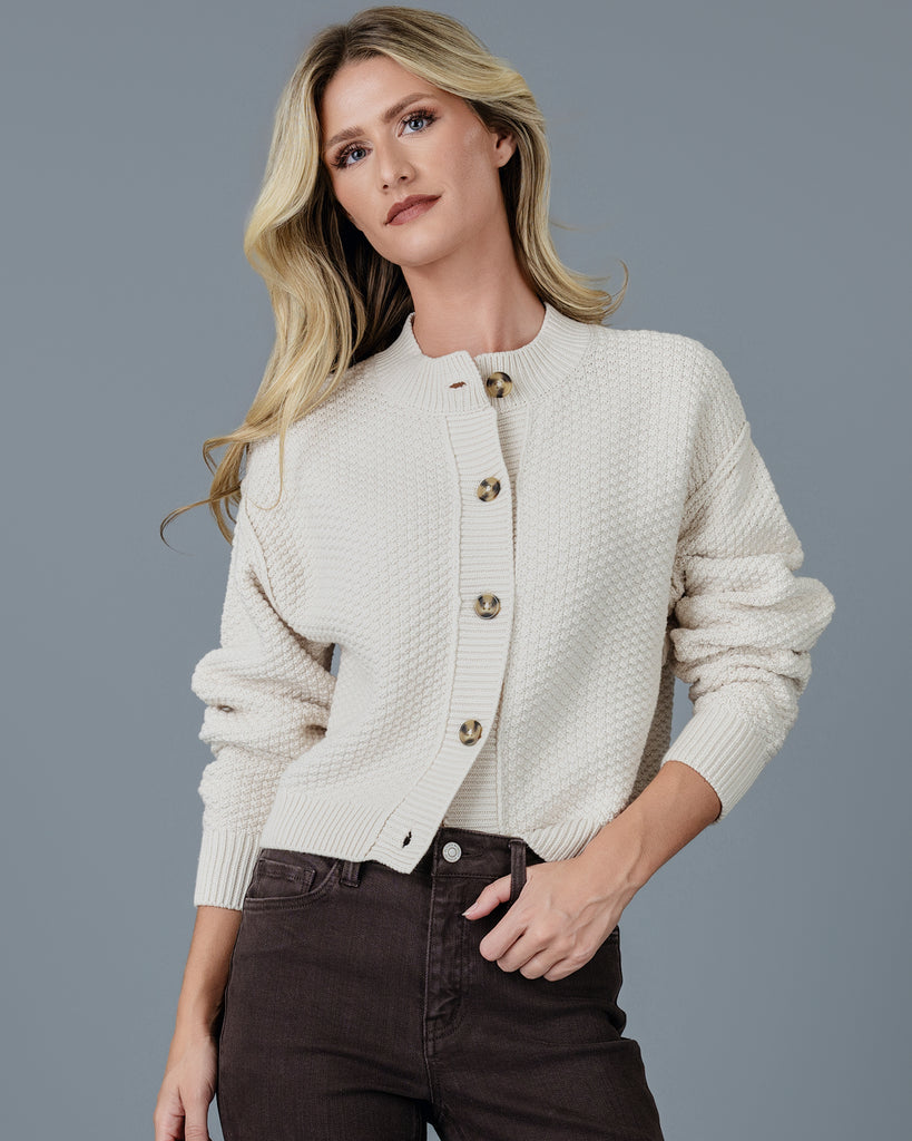 Woman in a beige long sleeve textured cardigan