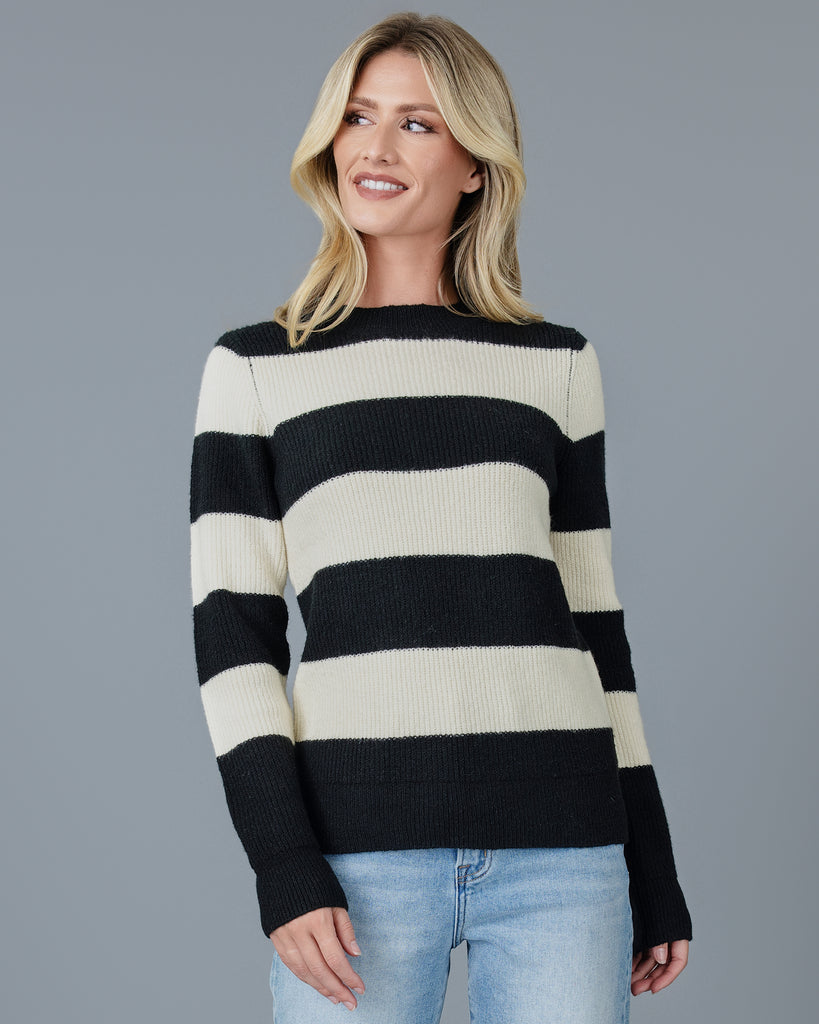 Woman in a black and white striped long sleeve sweater