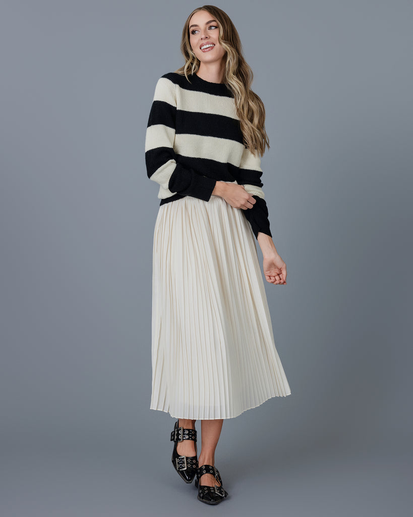 Woman in a black and white striped long sleeve sweater