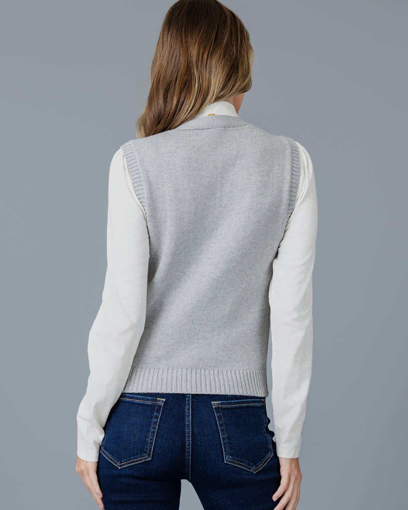 Woman in a grey cardigan vest 