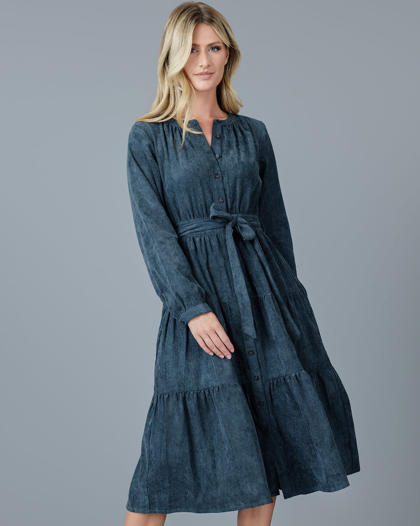 Woman in a blue velvet-y corduroy long sleeve midi dress