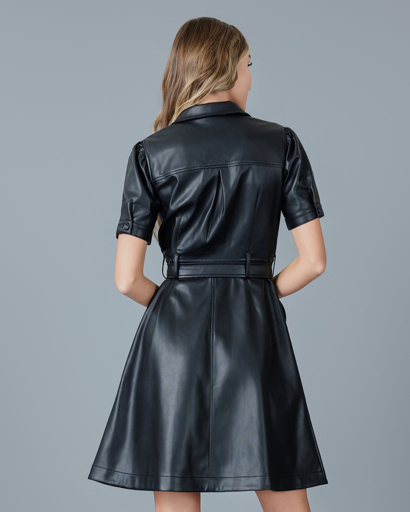 Woman in a black vegan leather short sleeve knee-length dress