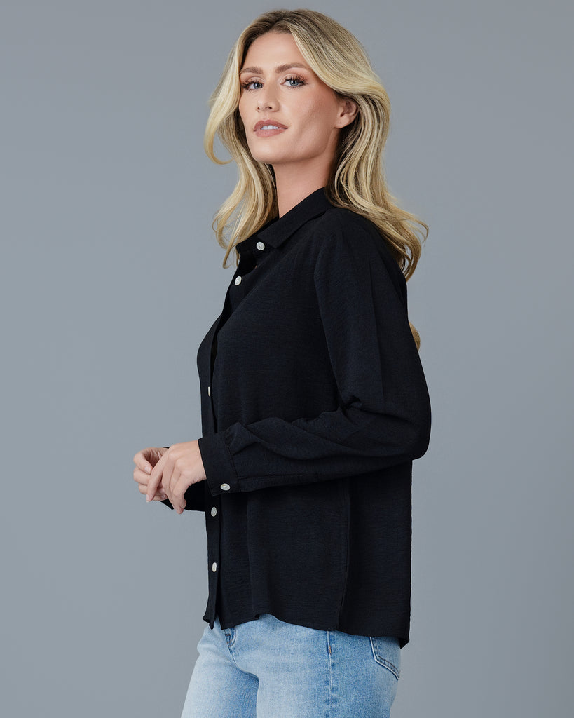 Woman in a black long sleeve buttondown blouse