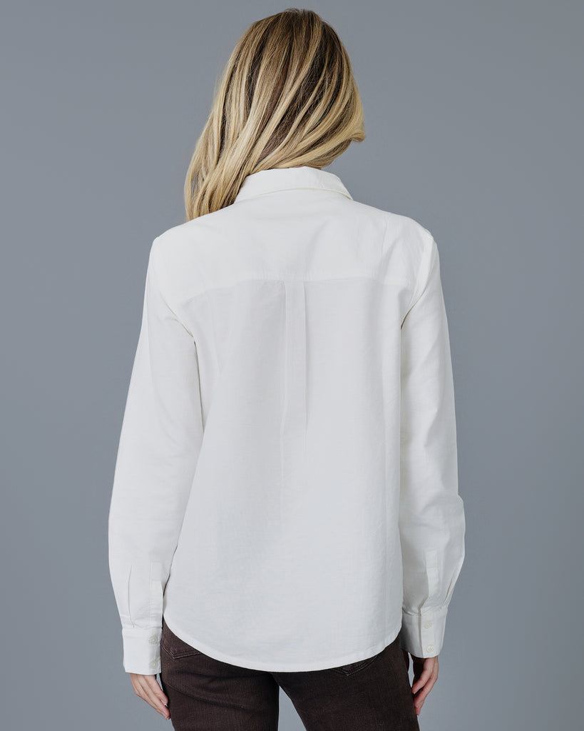 Woman in a white long sleeve buttondown 