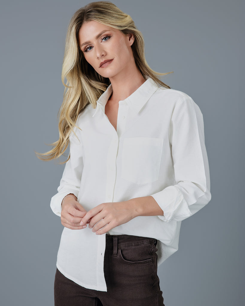 Woman in a white long sleeve buttondown 