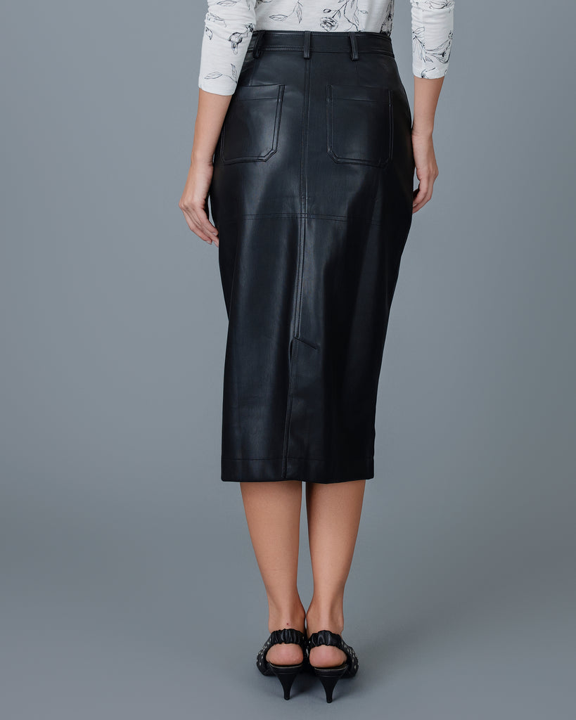 Woman in a black vegan leather midi length skirt