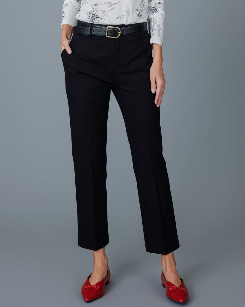 Woman wearing black tapered trousers