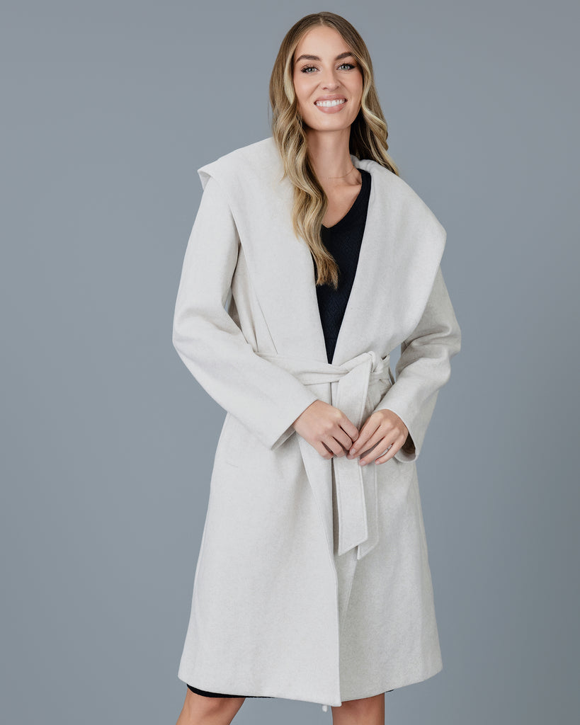 Woman in a tan long sleeve coat