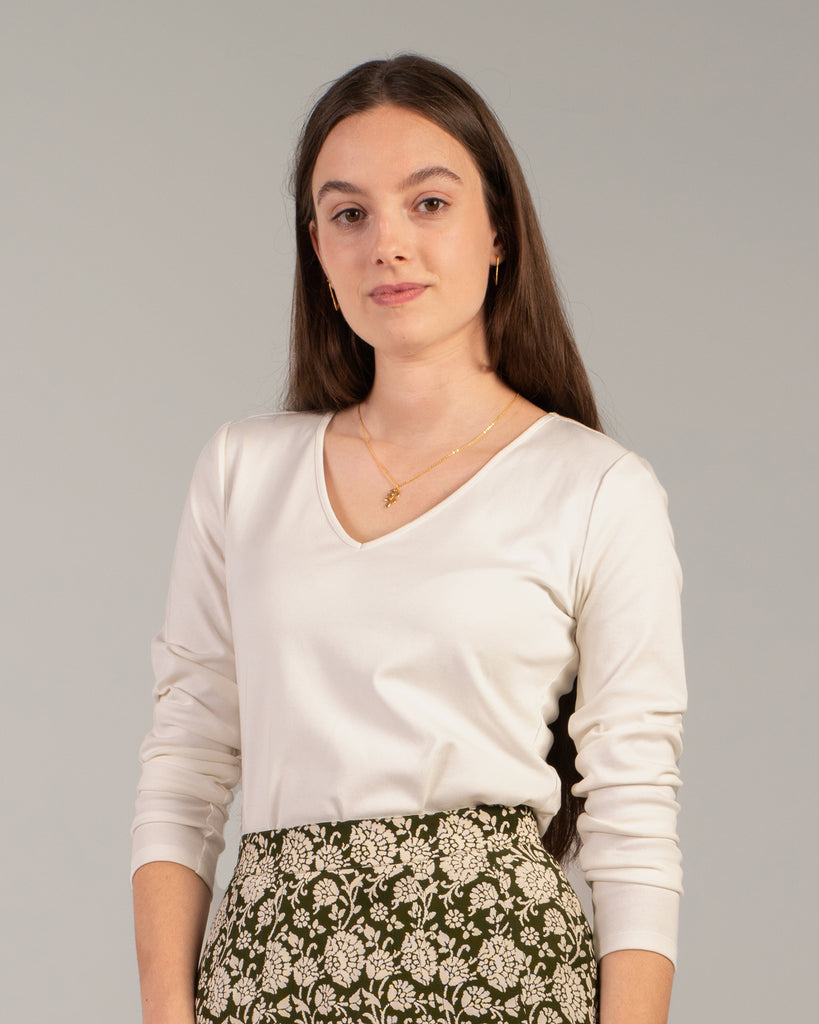 Woman in a white long sleeve v-neck tee