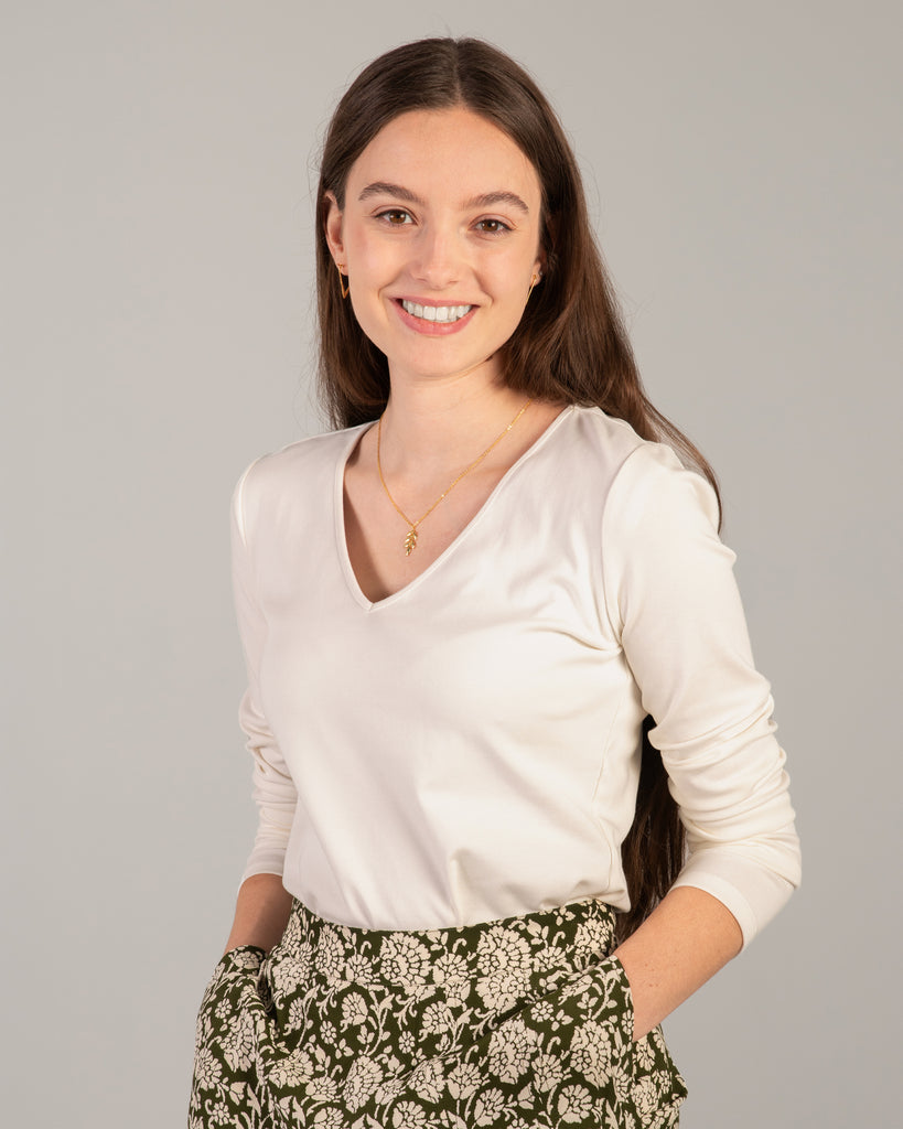 Woman in a white long sleeve v-neck tee