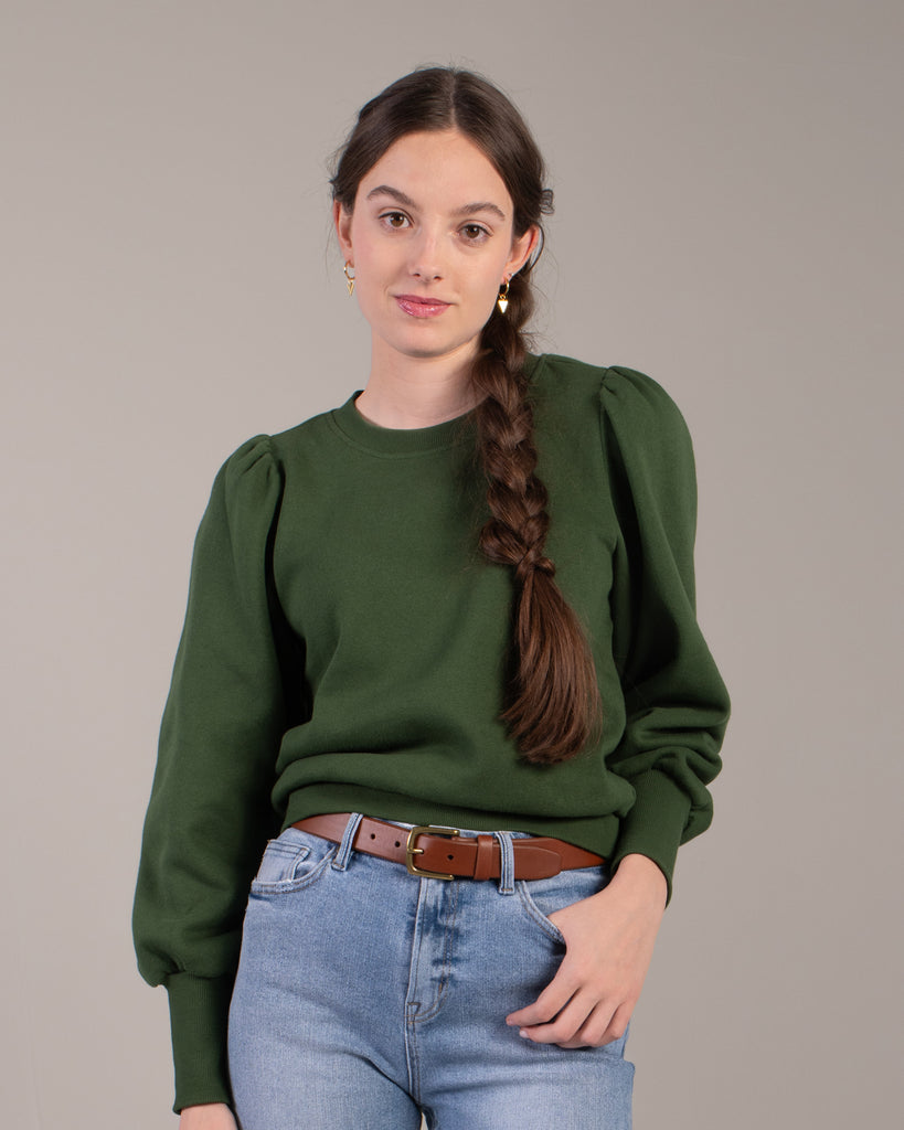 Woman in a green puffed shoulder sweatshirt