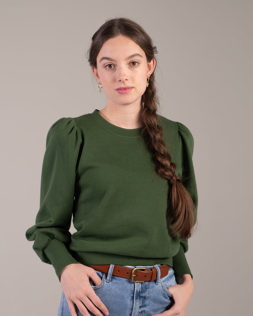 Woman in a green puffed shoulder sweatshirt