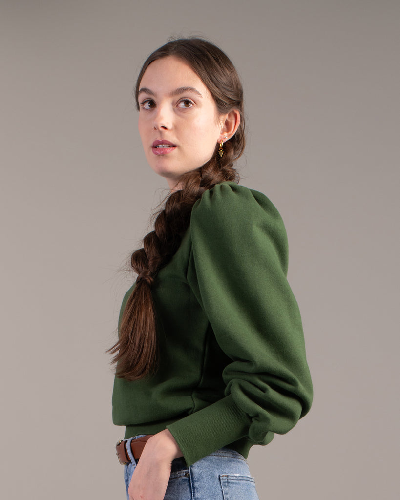 Woman in a green puffed shoulder sweatshirt